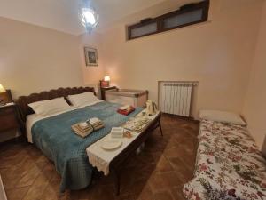a bedroom with a bed and a table with plates on it at Linda's Retreat B&B in Fiano Romano