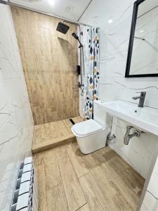 a bathroom with a toilet and a sink at Kolsay Eco House in Saty
