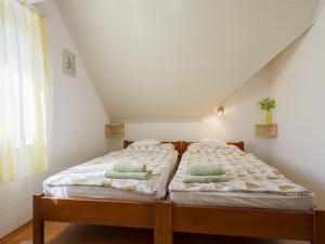 a bedroom with two beds in a attic at Apartment Times by Interhome in Badacsonytördemic +36 photos