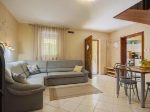 a living room with a couch and a table at Apartment Times by Interhome in Badacsonytördemic