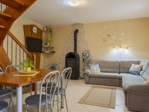 a living room with a couch a table and a fireplace at Apartment Times by Interhome in Badacsonytördemic