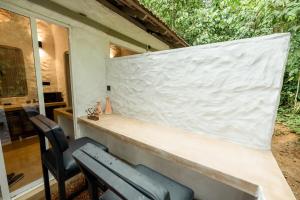 a white wall on the side of a house at Clove Bentota in Walagedera