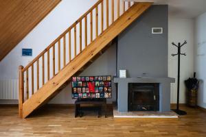 a staircase in a living room with a fireplace at Apto Aloha Panticosa | Piscina | WIFI | Vistas in Panticosa