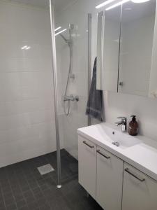a white bathroom with a shower and a sink at Villa Catharina in Kristinestad +8 photos