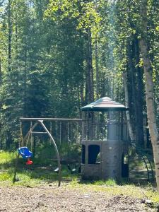 a small playground with a swing and a play structure at Houston Grass Station Campsite #42 in Wasilla