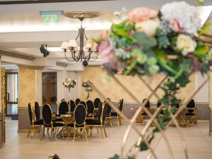 a banquet hall with chairs and flowers on the wall at Pensiunea Florica in Piteşti