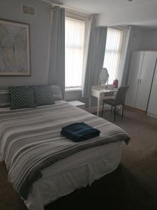 a bedroom with a bed with a blue towel on it at The Kirkview in Blackpool