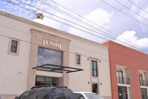 a building with cars parked in front of it at Posada La Noria in Sombrerete