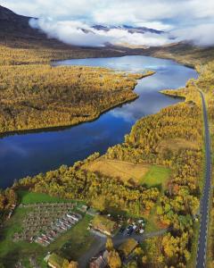 an aerial view of a lake and a road at Guesthouse / Huskyfarm Innset in Innset