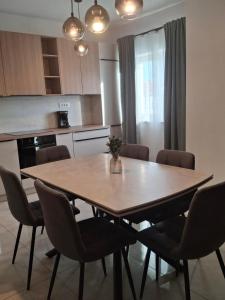 a kitchen with a dining room table and chairs at Adriatic Pearl Povile in Povile