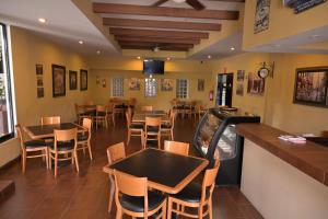 a dining room with tables and chairs in a restaurant at Posada La Noria in Sombrerete