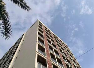 a tall white building with a sky in the background at Casa Lucia in Pune