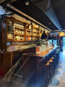 a bar with bar stools in a restaurant at Beach Hotel Katwijk in Katwijk