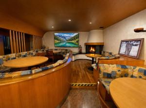 a restaurant with tables and chairs and a large screen at Hotel International in Tarvisio +22 photos