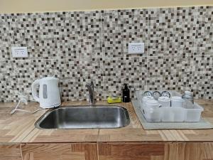 a kitchen counter with a sink in a kitchen at Alojamiento Las Termas in Fiambalá