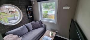 a living room with a couch and a window at The Red Mini Cottage in Huddinge