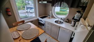 a small kitchen with a table and a sink at The Red Mini Cottage in Huddinge