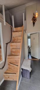 a wooden stair case in a room with at The Red Mini Cottage in Huddinge