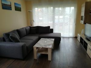a living room with a couch and a coffee table at Bungalow Schwielochsee in Schwielochsee