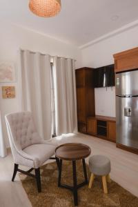 a living room with a chair and a table at Santa Delfina Suites in Flores