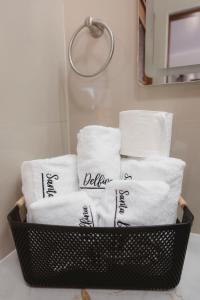 a basket filled with towels in a bathroom at Santa Delfina Suites in Flores