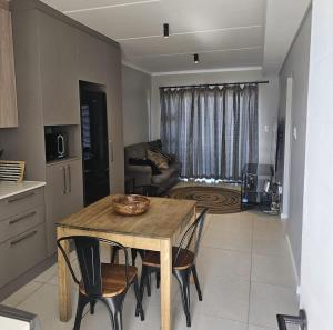 a kitchen and living room with a table and chairs at R&R at Summerview Sonstraal Heights in Windsor Park