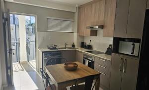 a kitchen with a table with a bowl on it at R&R at Summerview Sonstraal Heights in Windsor Park +2 photos