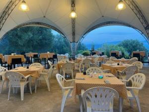 a restaurant with tables and chairs in a tent at Locanda a Bosco in Bosco
