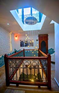 a room with a staircase with a chandelier at Dar Al Massir in Chefchaouen