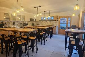a restaurant with wooden tables and chairs in a kitchen at Casa Fran Valparaíso | Vive un Hotel Temático in Valparaíso