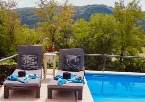 a couple of chairs sitting next to a swimming pool at Apartman Verona Buzet in Buzet
