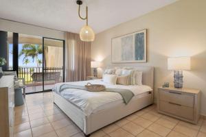 a bedroom with a large bed and a balcony at Boho 2BR Retreat - Ocean View Terrace & Pool in Buena Vista