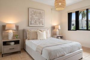a bedroom with a large bed with two night stands at Boho 2BR Retreat - Ocean View Terrace & Pool in Buena Vista +26 photos