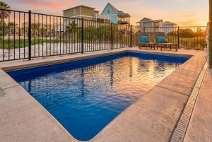 a swimming pool in a yard with a fence at Bright Waves Fort Morgan in Gulf Shores