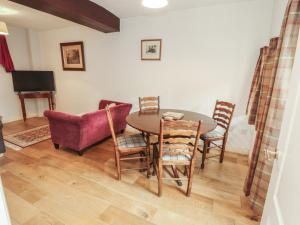 a dining room with a table and chairs at Millers Cottage in Wigton