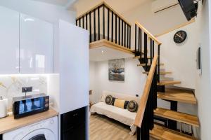 a room with a staircase and a living room with a couch at Louis House in Rhodes Town
