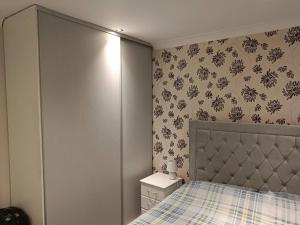 a bedroom with a bed and a dresser in it at Dublin Cosy Home in Dublin