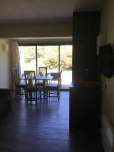 a dining room with a table and chairs and a window at Appartement village 7 in Arles +1 photo