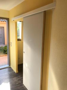 an open door in a room with a hallway at Appartement village 7 in Arles