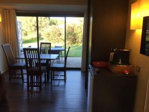 a dining room with a table and chairs and a window at Appartement village 7 in Arles