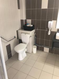 a bathroom with a toilet and a sink at Appartement village 7 in Arles