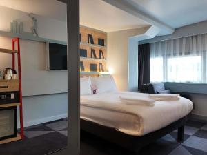 a hotel room with a large bed and a window at ibis Styles Ankara in Ankara