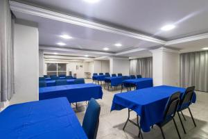 a conference room with blue tables and chairs at Hotel Nacional Inn Recife Aeroporto in Recife +35 photos