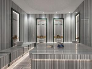 a lobby with a row of sinks and mirrors at Mercure Antalya Belek in Belek