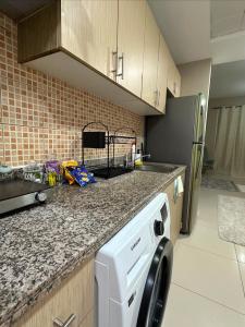 a kitchen with a dishwasher and a counter top at Cosy Studio - Desert Breeze in Ghantoot