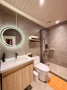 a bathroom with a sink and a toilet and a mirror at I WoW in Xiaoliuqiu +47 photos