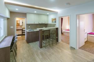a kitchen and living room with a table and chairs at Pansion Rose in Mostar