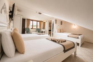 a bedroom with two beds and a living room at La Paloma Hotel in Antalya +46 photos