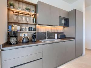 a kitchen with stainless steel cabinets and a sink at Villa Florinda by Interhome in Raša