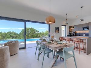 a kitchen and dining room with a table and chairs at Villa Florinda by Interhome in Raša